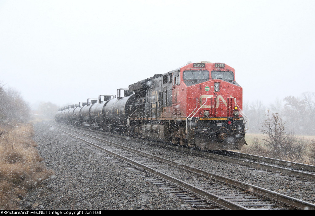 As another band of snow comes through, CN 3055 heads away as the rear DPU on U756